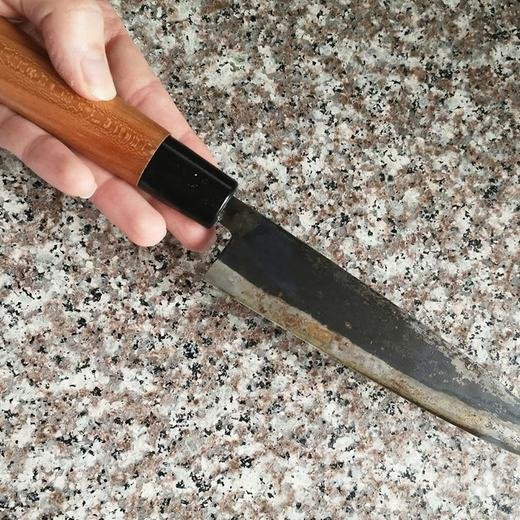 Knife being used on a glass or stone surface